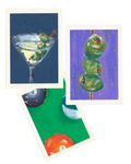 Three small art prints with white borders are arranged on a white background. The top-left print shows a martini glass with green olives on a dark blue background.